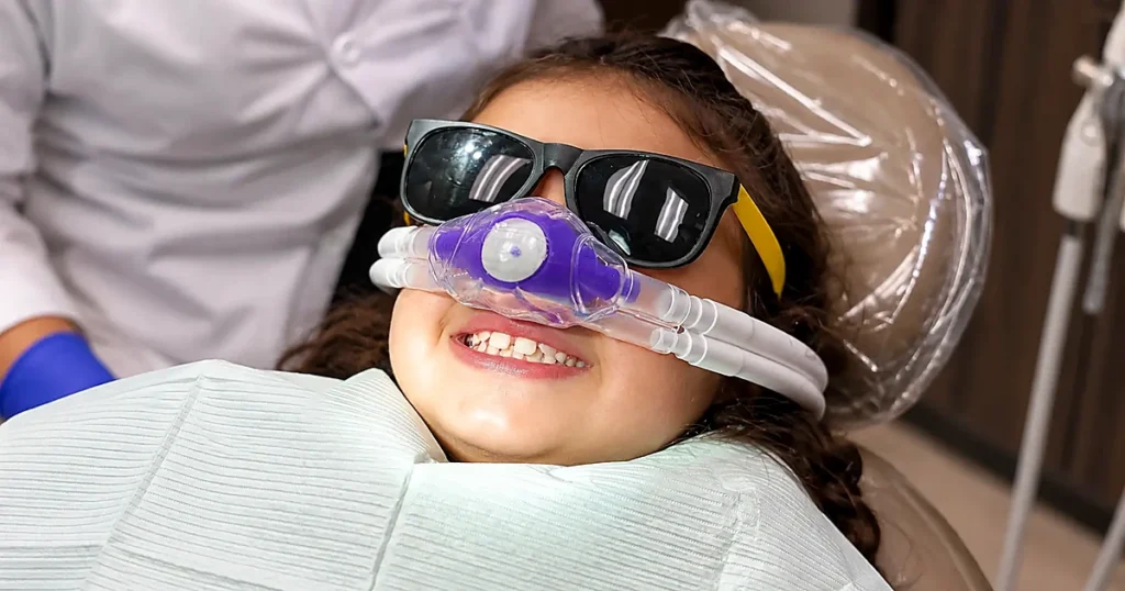 A pediatric dentistry patient smiles throughout the entire procedure with a dentist in Roanoke, TX.