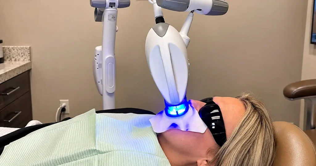 A patient is undergoing a Zoom teeth-whitening procedure at Garden Valley Dental Clinic.